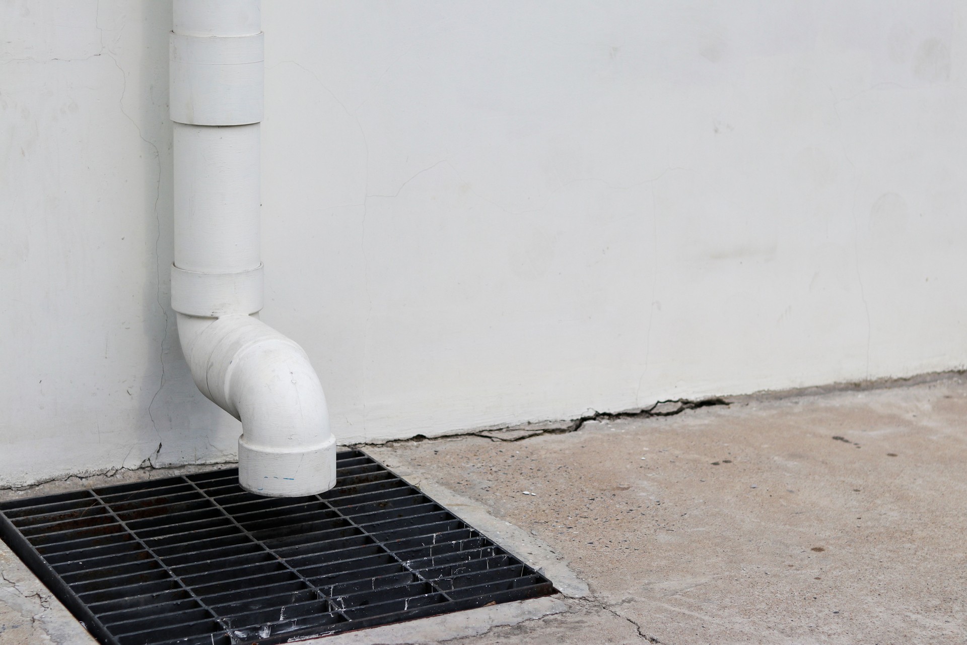 Rainwater pipes continue down from the top and discharged at the sewer.
