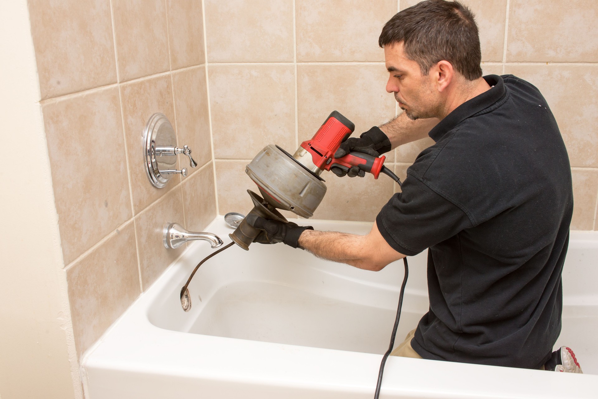 Plumber snaking drain